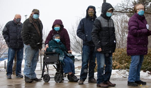 People aged 80 and older line up outside a sports centre in Richmond Hill, Ont. on Monday to be among the first participants in York Region's mass vaccination program against COVID-19.