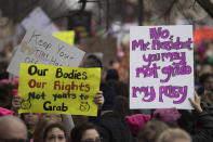 <p>Demonstrators carry placards as they march on Independence Avenue during the Women’s March on Washington in Washington, DC, January 21, 2017. (JIM WATSON/AFP/Getty Images) </p>