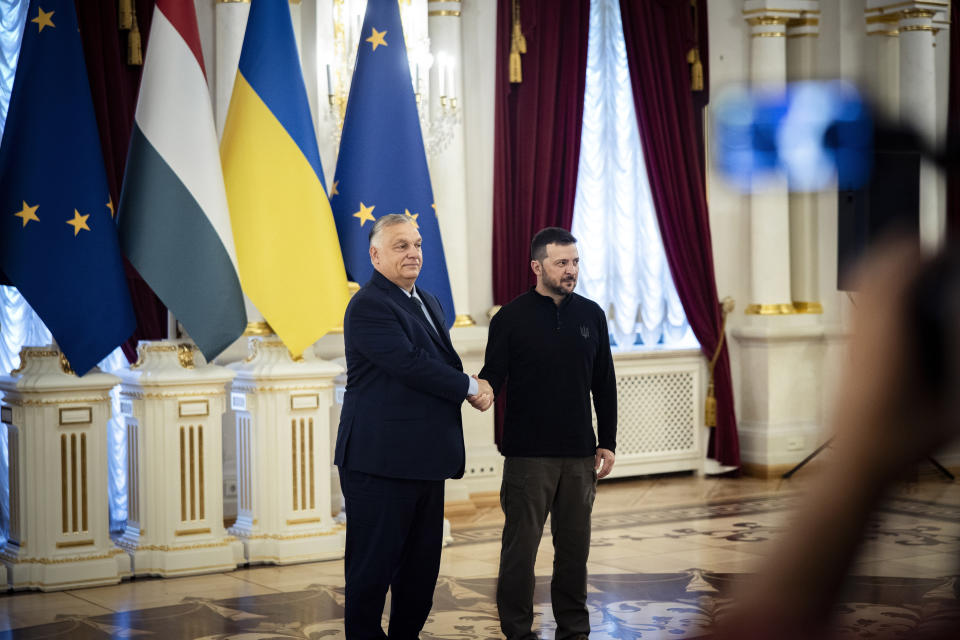 In this picture issued by the Hungarian PM's Press Office Ukrainian President Volodymyr Zelenskyy, right, welcomes Hungarian Prime Minister Viktor Orban in Kyiv, Ukraine, Tuesday, July 2, 2024. (Zoltan Fischer/Hungarian PM's Press Office/MTI via AP)