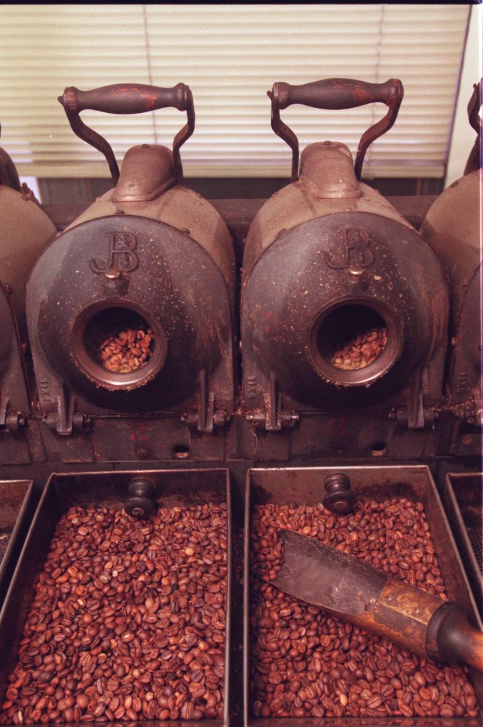 Heat from Folger’s coffee roasters, like these sample roasters seen at the plant in downtown Kansas City in 1997, made the area smell like coffee.