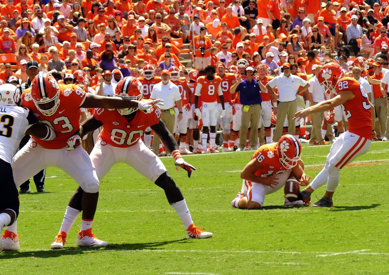 CLEMSON, SC – SEPTEMBER 2: Wide receiver Will Swinney holds the ball for kicker Greg Huegel #92 of the Clemson Tigers as he kicks an extra point against the Kent State Golden Flashes on September 2, 2017 at Memorial Stadium in Clemson, South Carolina. (Photo by Todd Bennett/Getty Images)