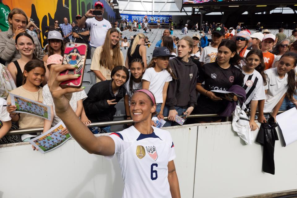 Team USA forward Lynn Williams takes selfies with fans in New Zealand earlier this year.