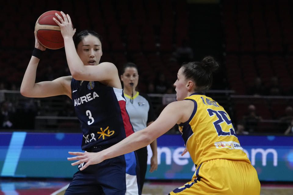 South Korea's Kang Leeseul looks to pass the ball past Bosnia and Herzegovina's Andela Delic during their game at the women's Basketball World Cup in Sydney, Australia, Saturday, Sept. 24, 2022. (AP Photo/Mark Baker)