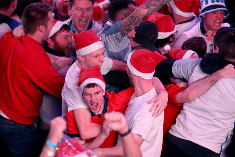 England fans celebrate their second goal of the game at BOXPARK Wembley in London, watch a screening of the Fifa World Cup 2022 Round of Sixteen match between England and Senegal (PA Wire)