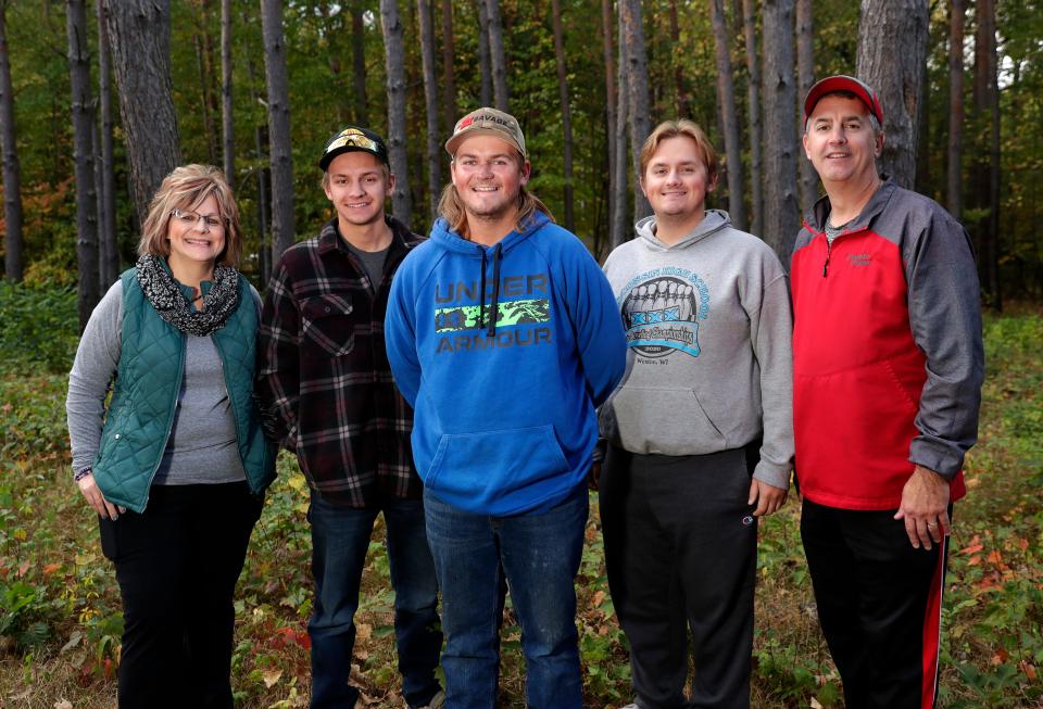 Brandon , center, pictured with his parents, Tammy and Bruce, and brothers, Zack and Josh, on Oct. 8, 2023, in Suamico, Wis. Brandon was severely injured a year ago in a bonfire explosion, suffering burns on nearly 40 percent of his body.