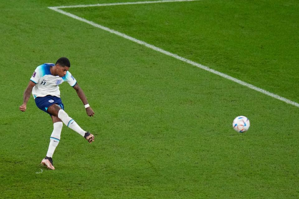 England's Marcus Rashford scores his side's first goal during the World Cup group B soccer match between England and Wales, at the Ahmad Bin Ali Stadium in Al Rayyan , Qatar, Tuesday, Nov. 29, 2022. (AP Photo/Alessandra Tarantino)