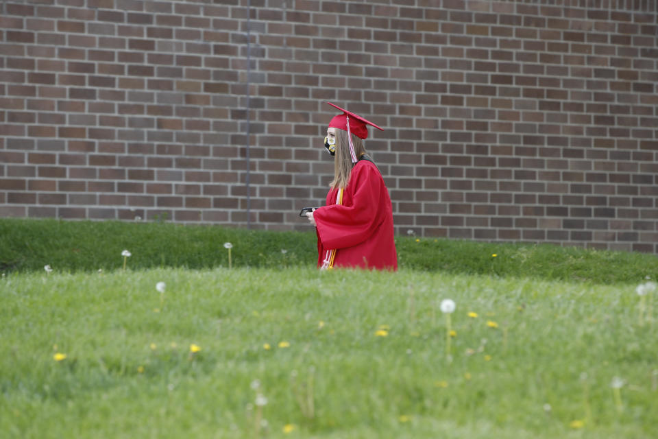 A graduate student arrives to pick up her diploma at Bradley-Bourbonnais Community High School on May 6, 2020 in Bradley, Illinois. - A speech by Barack Obama, a photo finish at Daytona, or a wild, livestreamed party in the family living room? Americans are dreaming up creative ways to celebrate their graduates, deprived of traditional diploma ceremonies by the coronavirus pandemic.High school and university graduation ceremonies are much-anticipated rites of passage in the United States, almost "as important as weddings or births," says 29-year-old Trent Johnson.  So when, after four years of medical school, he received an email telling him that his university, Ohio State, was cancelling the ceremony because of the pandemic, he was overwhelmed. (Photo by KAMIL KRZACZYNSKI / AFP) (Photo by KAMIL KRZACZYNSKI/AFP via Getty Images)