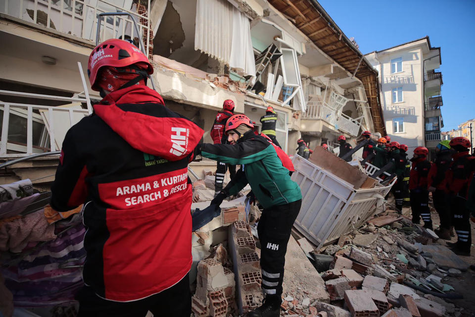 Rescuers searching for people buried under the rubble of a collapsed building, after an earthquake struck Elazig, eastern Turkey, Saturday, Jan. 25, 2020. Emergency workers and security forces distributed tents, beds and blankets as overnight temperatures dropped below freezing in the affected areas. Mosques, schools, sports halls and student dormitories were opened for hundreds who left their homes after the quake. (IHH/ Humanitarian Relief Foundation via AP)