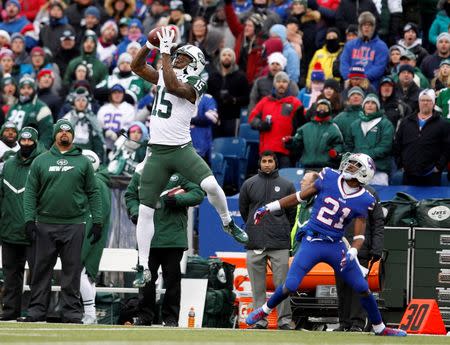 Jan 3, 2016; Orchard Park, NY, USA; New York Jets wide receiver Brandon Marshall (15) jumps to make a catch while being defended by Buffalo Bills strong safety Leodis McKelvin (21) during the first half at Ralph Wilson Stadium. Mandatory Credit: Timothy T. Ludwig-USA TODAY Sports