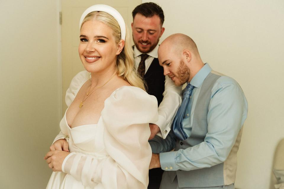 <p>Tony Hailstone Photography / SWNS</p> Reagen Varross (right) working on the dress he made for his sister, Brooke Evans