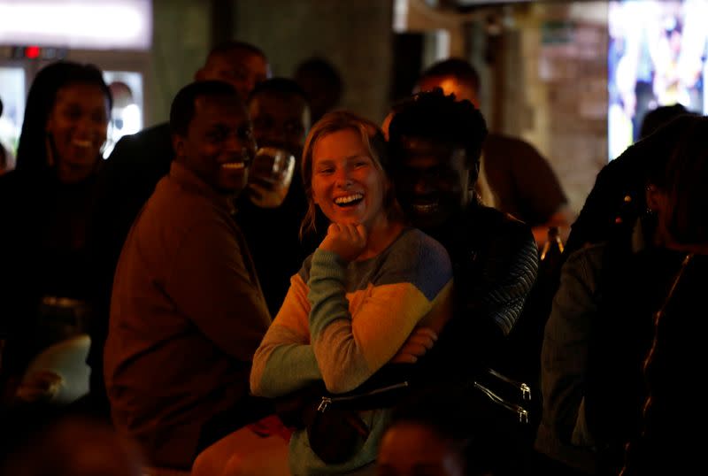 People in the audience laugh during a standup show by Kenyan comedian Brian Onjoro at the Kez's Kitchen restaurant in Nairobi