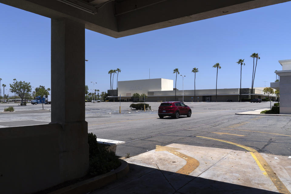 This Thursday, May 27, 2021, photo shows the closed Sears in Buena Park Mall in Buena Park, Calif. California state lawmakers are grappling with a particularly 21st-century problem: What to do with the growing number of shopping malls and big-box retail stores left empty by consumers shifting their purchases to the web. A possible answer in crowded California cities is to build housing on these sites, which already have ample parking and are close to existing neighborhoods. Even before the pandemic, big-box retail stores struggled to adapt as more people began buying things online. In 2019, after purchasing Sears and Kmart, Transformco closed 96 stores across the country, 29 in California. (AP Photo/Damian Dovarganes)