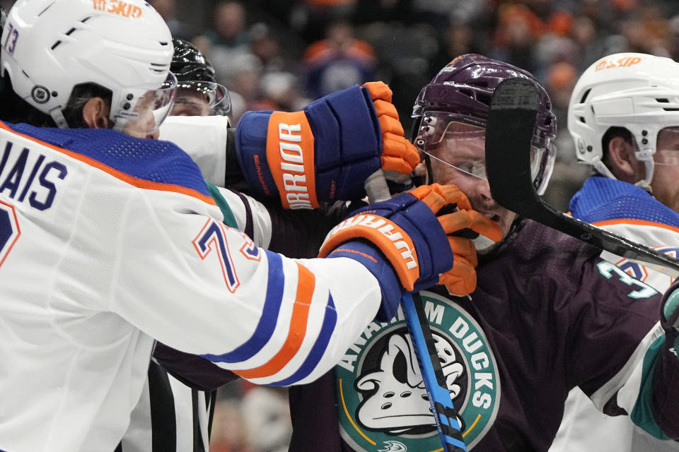 Edmonton Oilers defenseman Vincent Desharnais, left, scuffles with Anaheim Ducks center Sam Carrick during the first period of an NHL hockey game Sunday, Dec. 31, 2023, in Anaheim, Calif. (AP Photo/Mark J. Terrill)