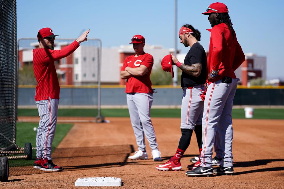 First base coach Collin Cowgill explains his expectations for baserunning with Spencer Steer, Jonathan India and Elly De La Cruz during workouts last week.