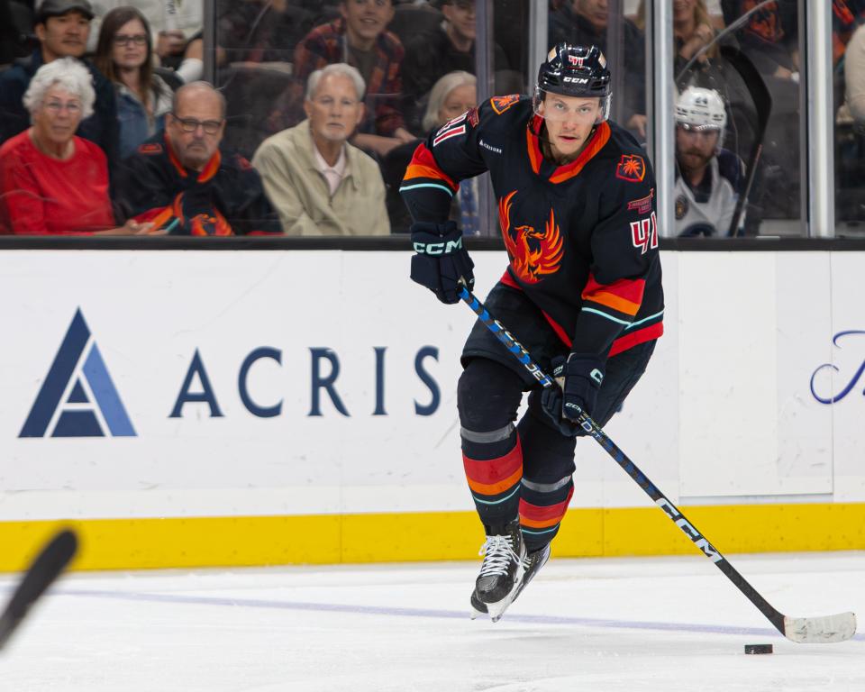 Coachella Valley Firebirds Ryker Evans (#41) scans the ice, looking for an open teammate to pass the puck during game 6 of the matchup against the Milwaukee Admirals at Acrisure Arena on June 5, 2023.