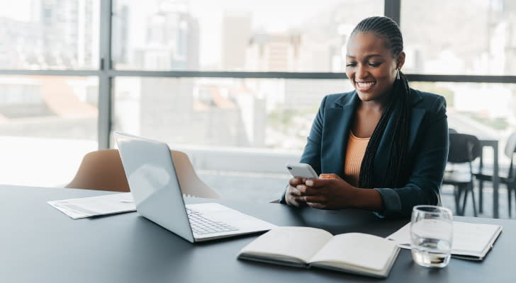 A financial advisor texting her colleagues after passing the CFP exam.