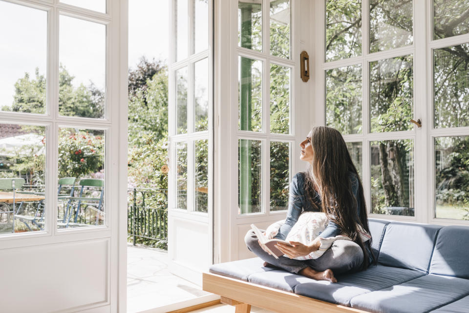 Woman sits in a sunny entryway