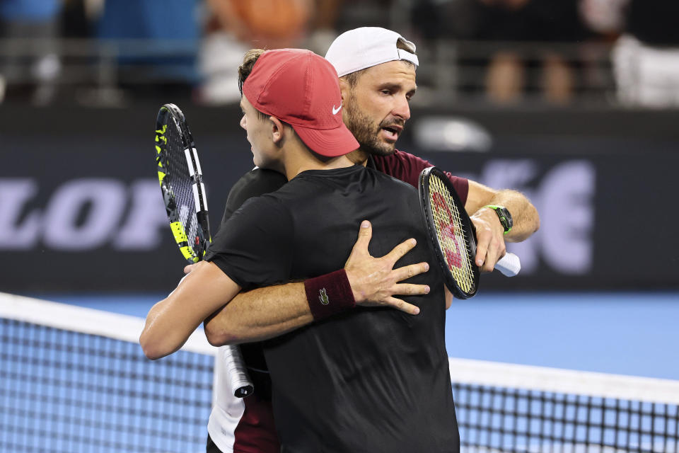 Grigor Dimitrov of Bulgaria hugs Holger Rune of Denmark after he won his final match 6-3, 7-5, during the Brisbane International tennis tournament in Brisbane, Australia, Sunday, Jan. 7, 2024. (AP Photo/Tertius Pickard)