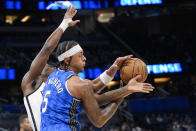 Orlando Magic forward Paolo Banchero (5) and Brooklyn Nets center Day'Ron Sharpe vie for a rebound during the first half of an NBA basketball game Wednesday, March 13, 2024, in Orlando, Fla. (AP Photo/John Raoux)