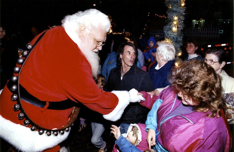 In this Nov. 22, 1993, file photo, Santa Claus aka Bud Kline, left, greets the crowd gathered for Holly Fest at Hagestown’s Public Square.