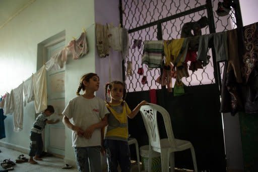 Two Syrian girls from Aleppo stand next to hanging laundry in a school being used to shelter displaced people in the town of Azaz, north of Aleppo, on August 11. The Syrian army has pounded rebel strongholds in Damascus province, where more than 45 people, including 36 civilians, have been killed in the past 48 hours, a watchdog said