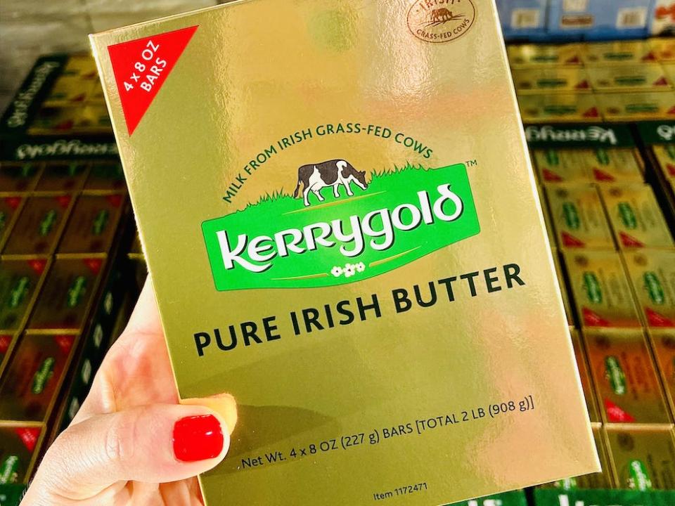 hand holding gold package of kerrygold irish butter