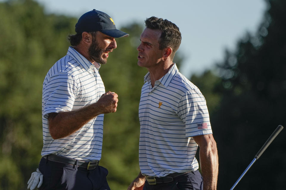 Max Homa celebrates with Billy Horschel after winning the 18th hole during their fourball match at the Presidents Cup golf tournament at the Quail Hollow Club, Friday, Sept. 23, 2022, in Charlotte, N.C. (AP Photo/Chris Carlson)