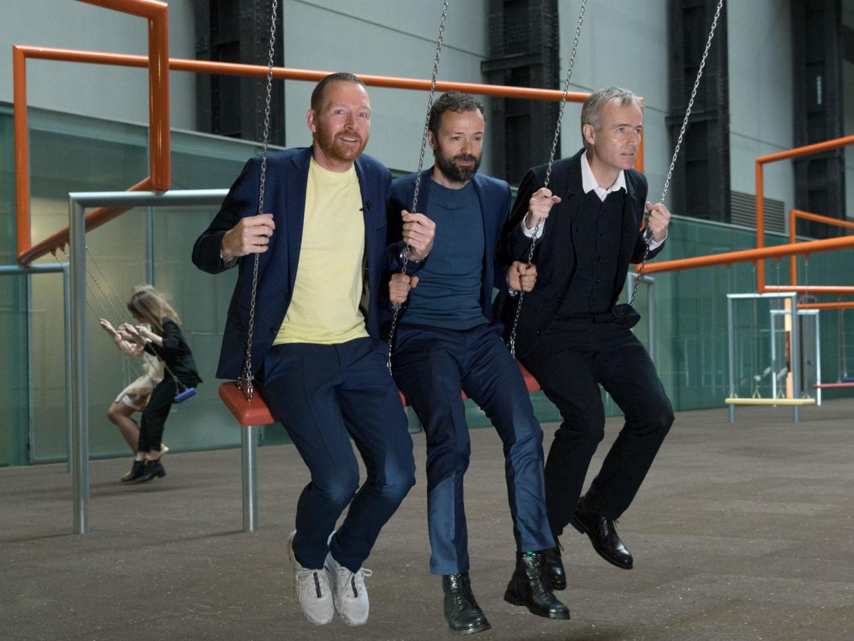 The Danish trio Superflux on swings at Tate's Turbine Hall which has been turned into a kids' playground called 'One Two Three Swing!'