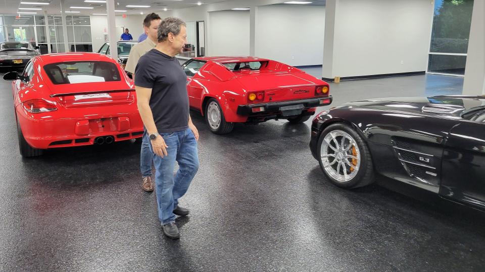 Jacksonville Sports Car Museum managing member David E. Gonzales (front) and his son, David A. Gonzales, inspect some of the vehicles at the soon-to-open facility.