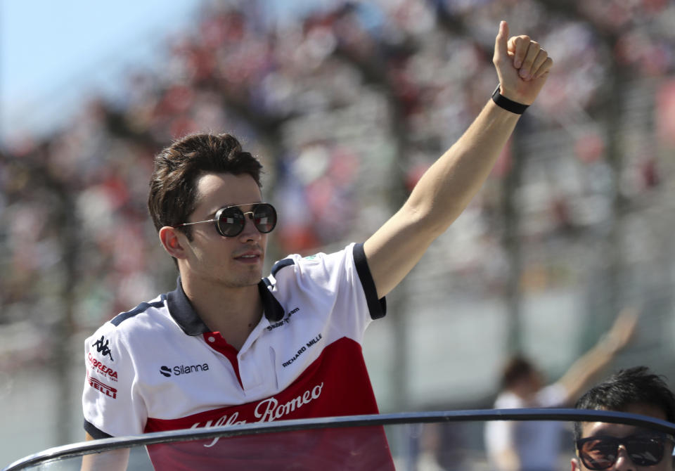Sauber driver Charles Leclerc of Monaco waves to the crowd during the drivers parade ahead of the Japanese Formula One Grand Prix at the Suzuka Circuit in Suzuka, central Japan, Sunday, Oct. 7, 2018. (AP Photo/Ng Han Guan)