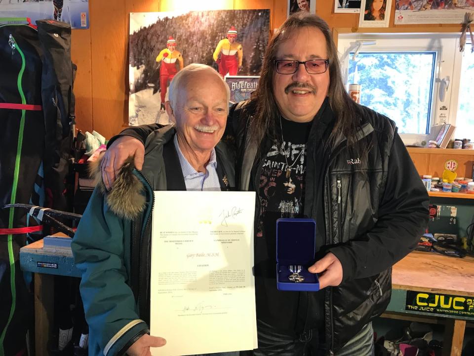 Yukon Commissioner Doug Phillips presenting a Governor General's Meritorious Service award to Gary Bailie, in Whitehorse.