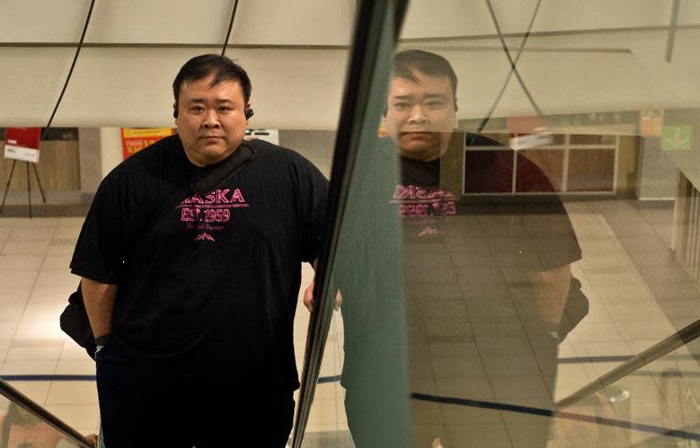 Malaysian civil engineer Kevin Lim makes his way up an escalator on the way to the fitness centre in Kuala Lumpur