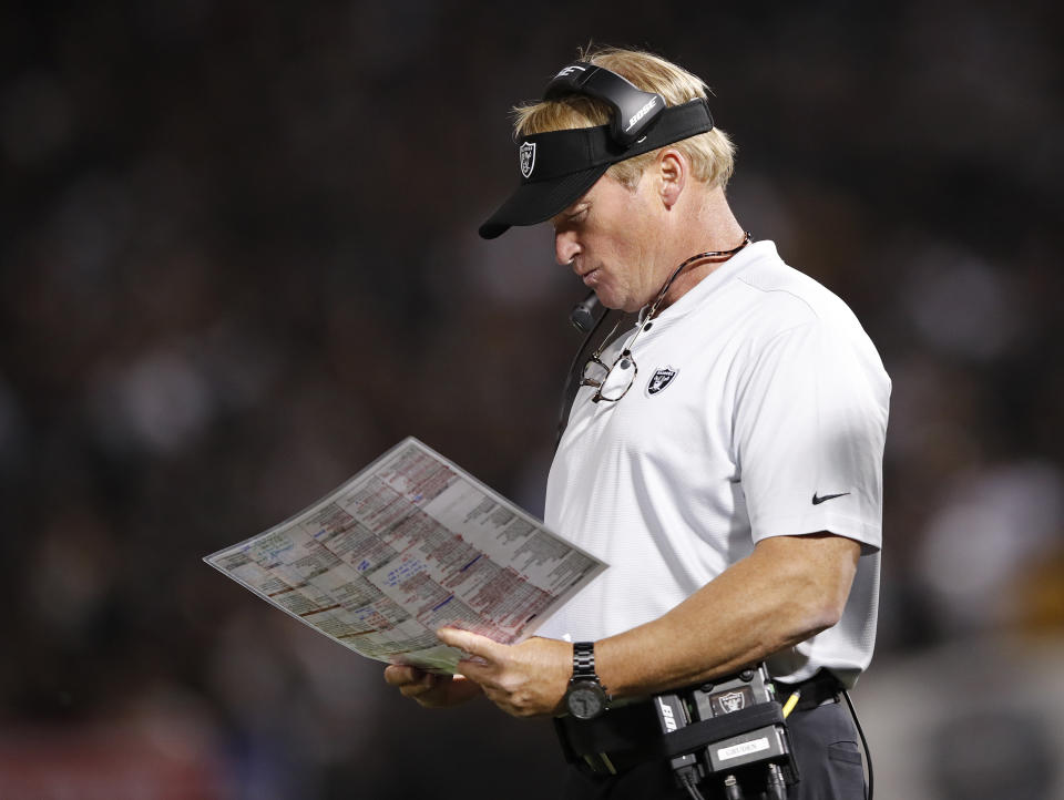 FILE - In this Sept. 10, 2018, file photo, Oakland Raiders coach Jon Gruden looks at at charts during the second half of the team's NFL football game against the Los Angeles Rams in Oakland, Calif. The winless Raiders play the Miami Dolphins, who have won twice, this week. (AP Photo/John Hefti)