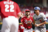 Cincinnati Reds third baseman Jonathan India (6) and starting pitcher Wade Miley (22) catch Los Angeles Dodgers' Corey Seager (5) in a run down between first and second base during the second inning of a baseball game in Cincinnati, Sunday, Sept 19, 2021. (AP Photo/Bryan Woolston)