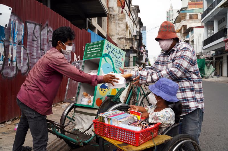 Cambodian cyclo-drivers pedal mobile food banks to deliver aid