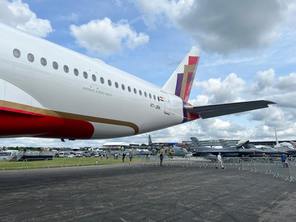 The tail assembly and registration VT-JRH of an Air India Airbus A350-900 on display at the 2024 Farnborough Airshow
