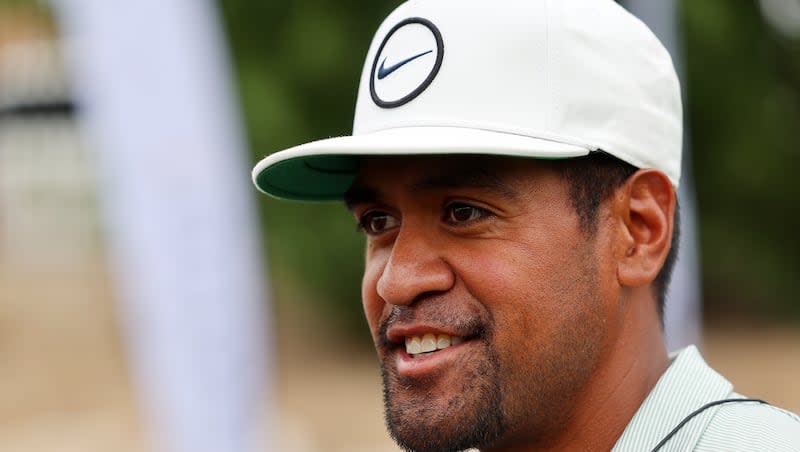 Professional golfer Tony Finau smiles as he and other golfers demonstrate golf strokes during the Tony Finau Foundation Golf Classic in Farmington on Monday, Aug. 1, 2022.