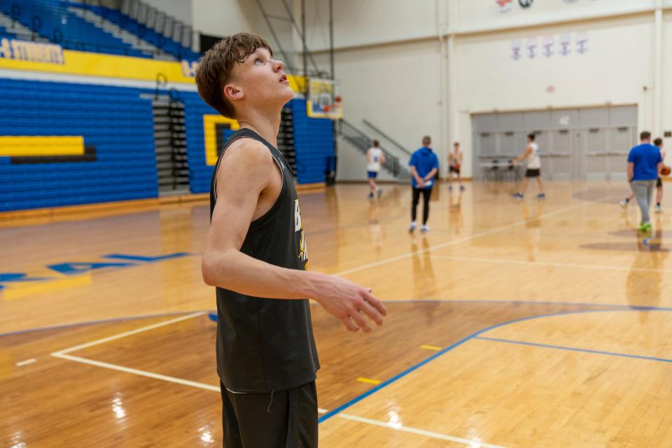 Braylon Mullins rebounds for a teammate on Tuesday, Feb. 14, 2023, during practice at Greenfield Central High School. 