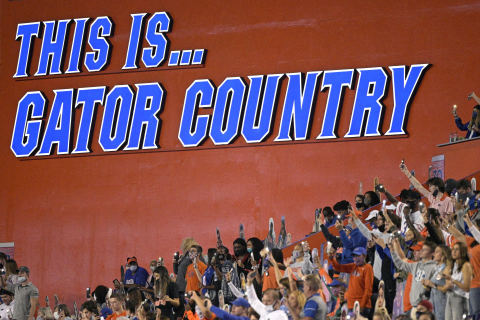 FILE - In this Nov. 14, 2020, file photo, Florida fans watch from the stands during the second half of an NCAA college football game against Arkansas in Gainesville, Fla. Florida’s athletic department had a $54.5 million shortfall during the 2020-21 fiscal year because of the coronavirus pandemic, significant financial losses the Gators were able to weather with a supplement from the Southeastern Conference and a sizeable reserve. (AP Photo/Phelan M. Ebenhack, File)