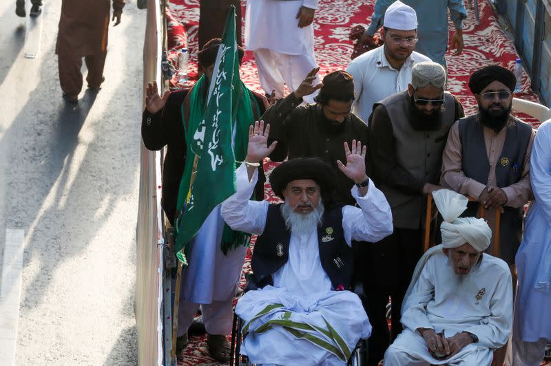 Khadim Hussain Rizvi of religious and political party Tehreek-e-Labaik Pakistan (TLP), gestures to his supporters during a protest against the cartoon publications of Prophet Mohammad in France, in Karachi