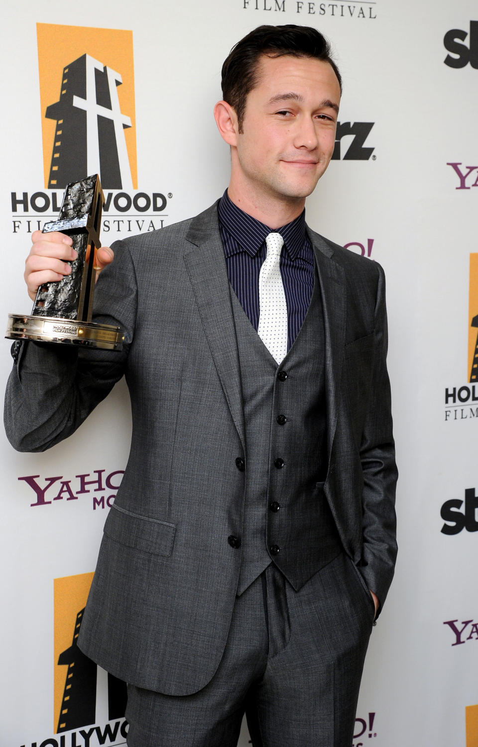 Joseph Gordon-Levitt poses backstage with the Hollywood breakthrough actor award at the 15th Annual Hollywood Film Awards Gala on Monday, Oct. 24, 2011 in Beverly Hills, Calif. (AP Photo/Kristian Dowling)