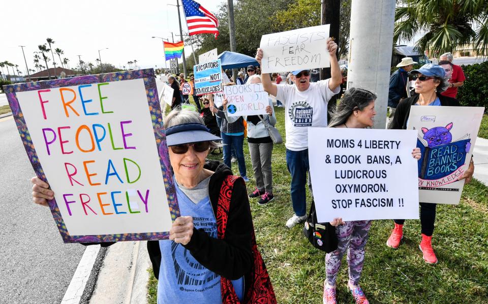 Dozens of people gathered along Babcock Street at Bulldog Boulevard in Melbourne on Saturday to protest against the banning of books. Craig Bailey/FLORIDA TODAY via USA TODAY NETWORK