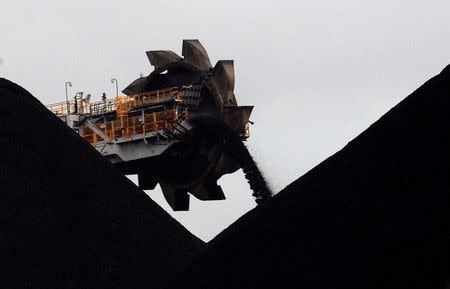 A reclaimer places coal in stockpiles at the coal port in Newcastle, Australia, June 6, 2012. REUTERS/Daniel Munoz/Files