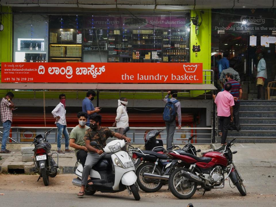 People line-up outside a Bangalore liquor store to make a last minute purchase ahead of a new lockdown: AFP via Getty Images