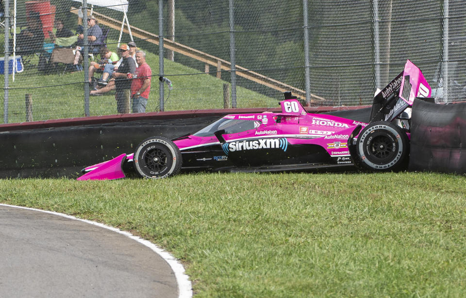 Jack Harvey of England (60) hits the fence during qualifying for the IndyCar Series auto race, at Mid-Ohio Sports Car Course, Sunday, Sept. 13, 2020, in Lexington, Ohio. (AP Photo/Phil Long)