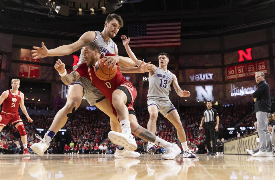 Nebraska's C.J. Wilcher, front, drives against Northwestern's Luke Hunger during the first half of an NCAA college basketball game Saturday, Jan. 20, 2024, in Lincoln, Neb. (AP Photo/Rebecca S. Gratz)