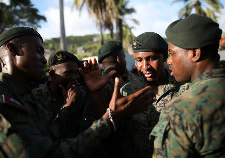 Members of the Haitian Armed Forces (FAD'H) shake hands after a parade in the streets of Cap-Haitien, Haiti, November 18, 2017. REUTERS/Andres Martinez Casares