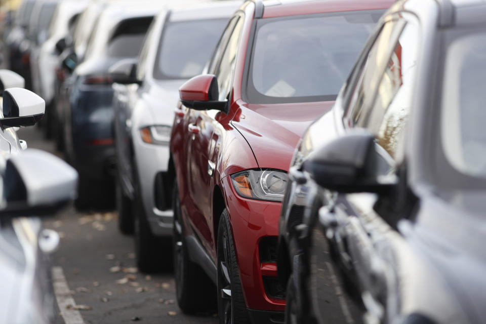 In this Nov. 10, 2019, photo a long row of unsold 2020 F-Pace sports-utility vehicles sits at a Jaguar dealership in Littleton, Colo. On Friday, Nov. 15, the Commerce Department releases U.S. retail sales data for October. (AP Photo/David Zalubowski)