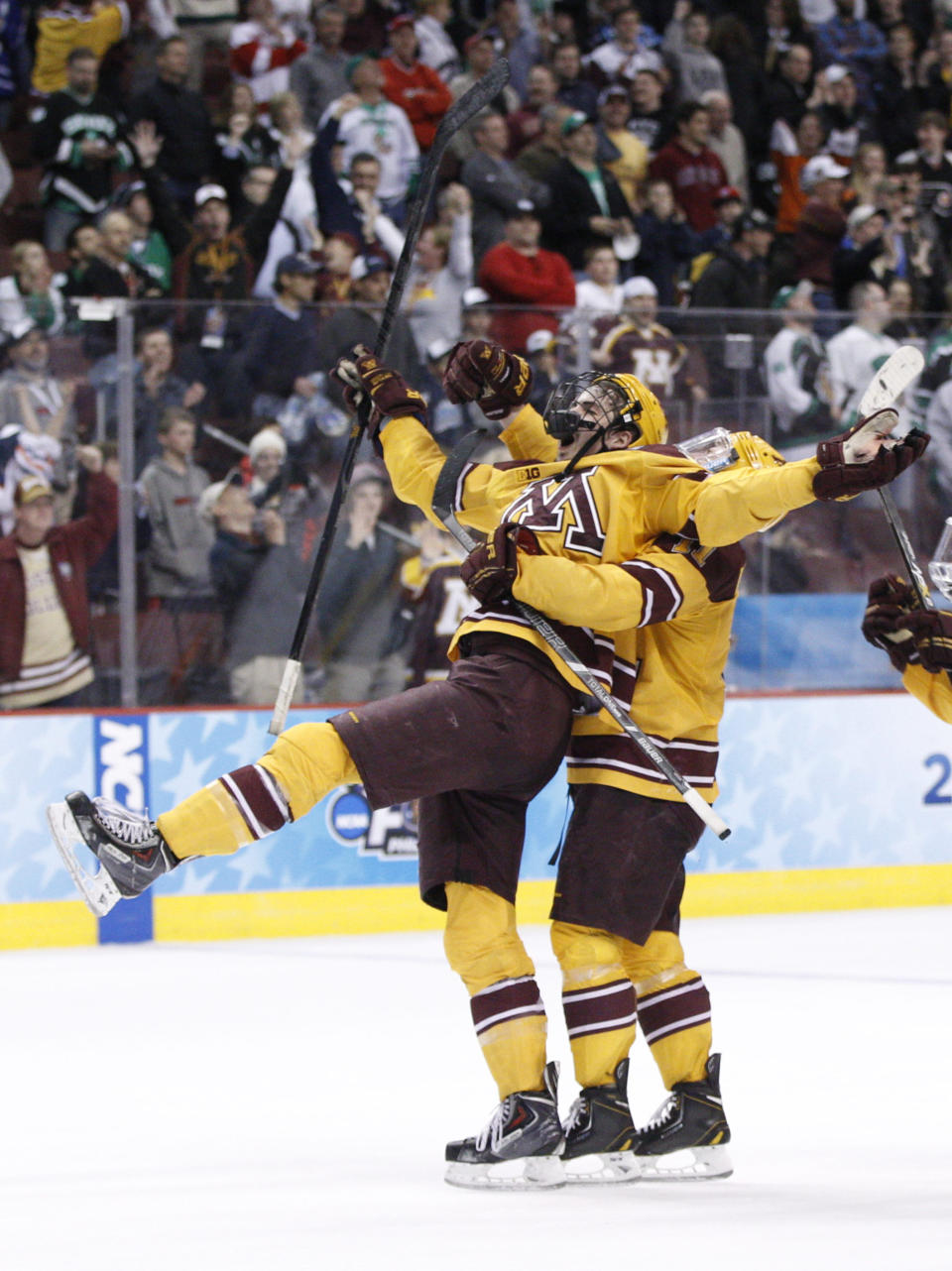 Minnesota's Justin Holl, left, reacts to his goal being ruled good with Sam Warning, right, behind him during the third period of an NCAA men's college hockey Frozen Four tournament game against North Dakota, Thursday, April 10, 2014, in Philadelphia. Minnesota won 2-1. (AP Photo/Chris Szagola)