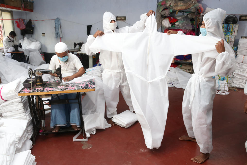 Indian Muslim Workers prepare personal protective equipment for medical staff at a workshop before their distribution to government hospitals during the countrywide 21 day lockdown amid concern over the spread of coronavirus, in Near Kolkata on April 5, 2020.A nationwide lockdown announced by Prime Minister Narendra Modi led to a mass exodus of migrant workers from cities to their villages, raising fears that the virus may have reached to the countryside, where health care facilities are limited. Experts say that local spreading is inevitable in a country where tens of millions of people live in dense urban areas with irregular access to clean water.  (Photo by Debajyoti Chakraborty/NurPhoto via Getty Images)